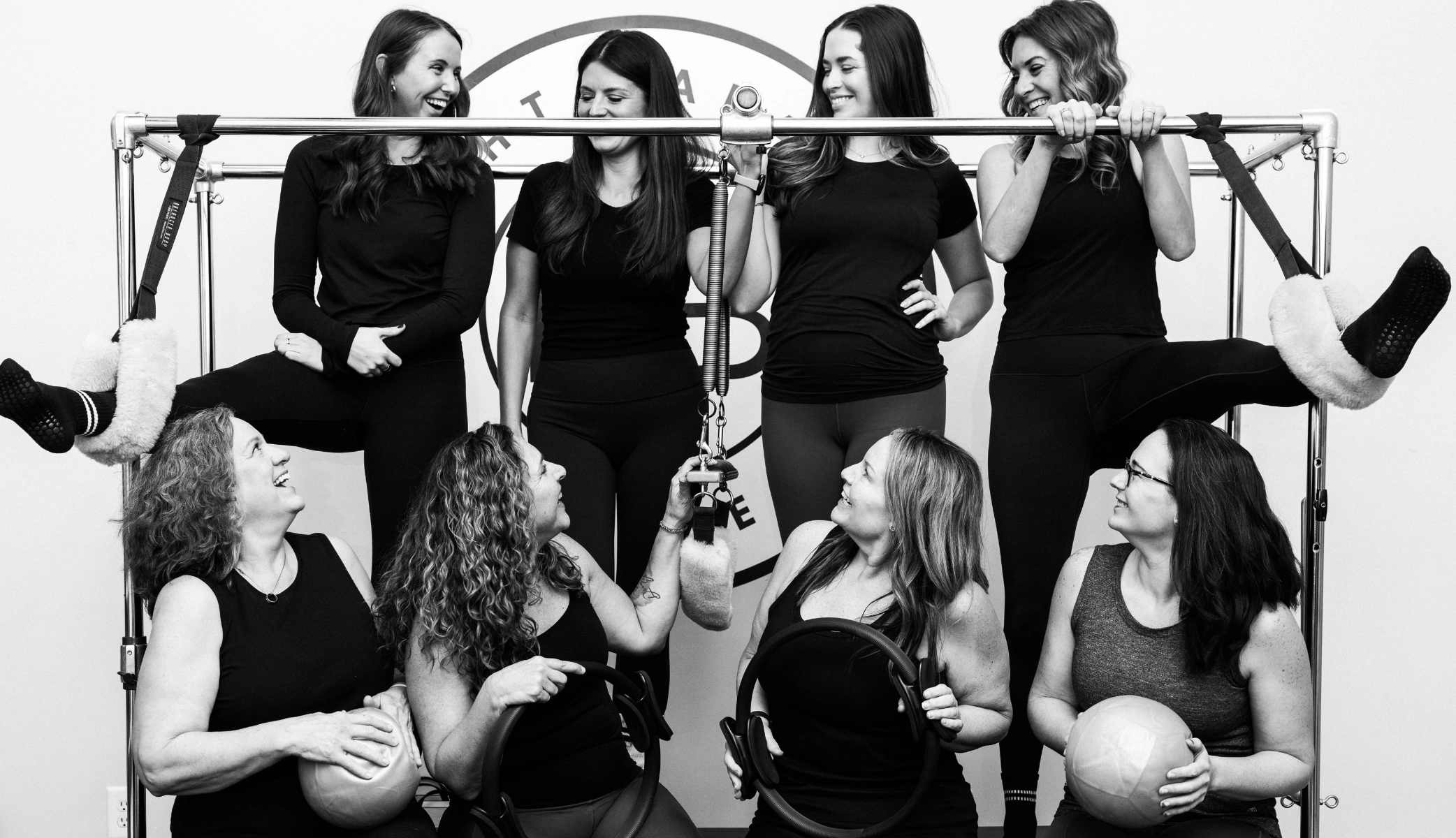 Pilates for beginners - smiling women holding Magic Circles during a group class at Right Balance Pilates