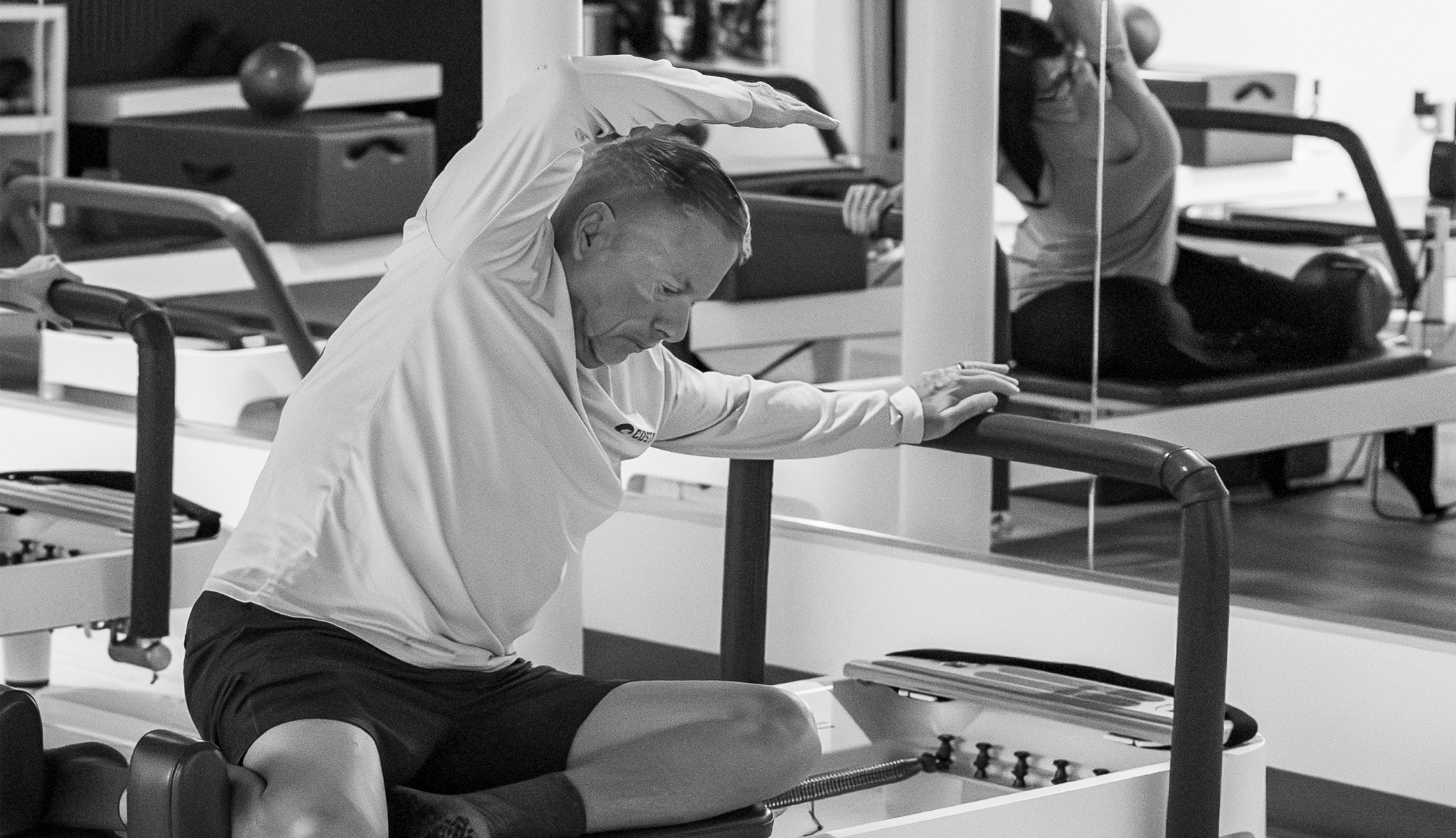 Man demonstrating exercises for lower back pain on a Pilates reformer at Right Balance Pilates