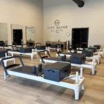 Row of Balanced Body Allegro 2 Reformers in a bright Right Balance Pilates studio
