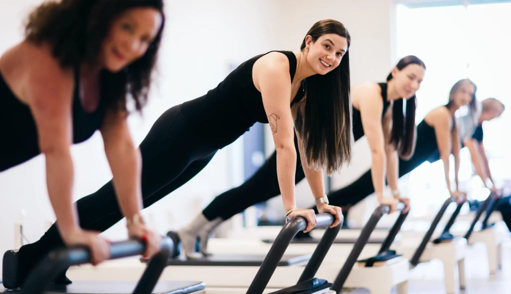 Instructor smiling during a free Intro to Pilates class on a Reformer at Right Balance Pilates in Middletown, DE