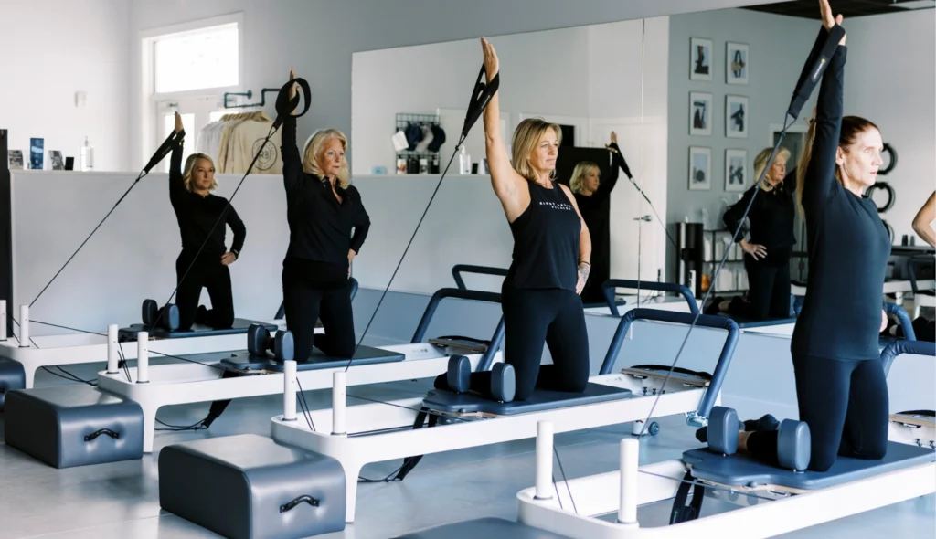 Four women taking a Reformer class at the new Middletown Pilates studio