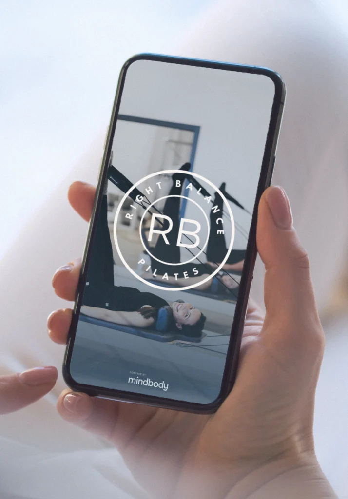 Client opening the Right Balance Pilates App to book a class at a Delaware studio