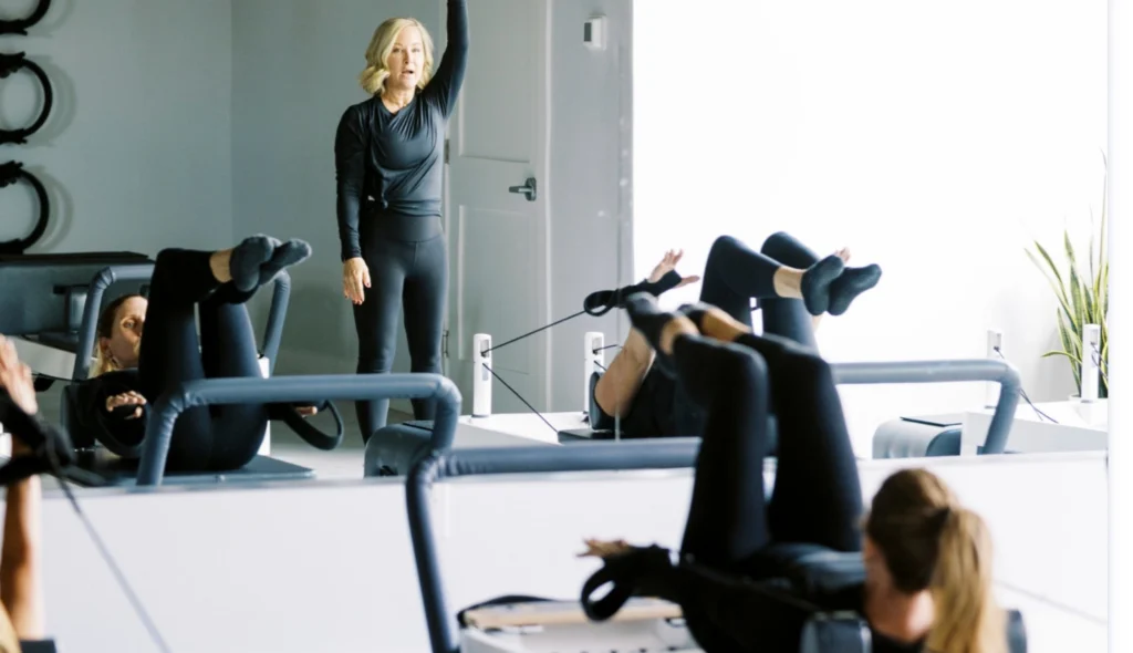 Instructor leading a free intro class on Balanced Body Allegro 2 Reformers at the new Pilates studio Middletown DE